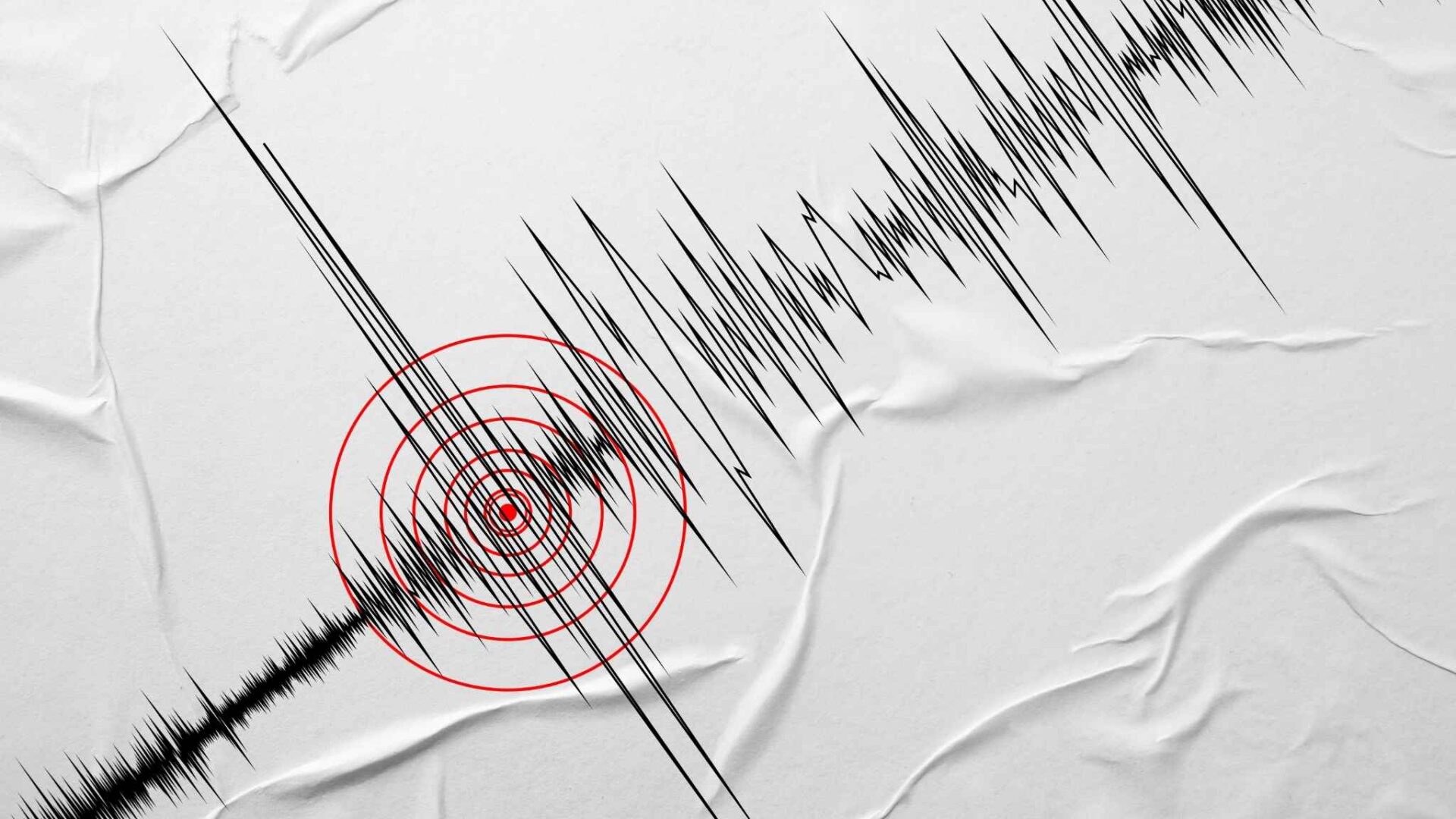 gráfico de sismo con ondas sísmicas y punto de impacto representando sueño con temblor